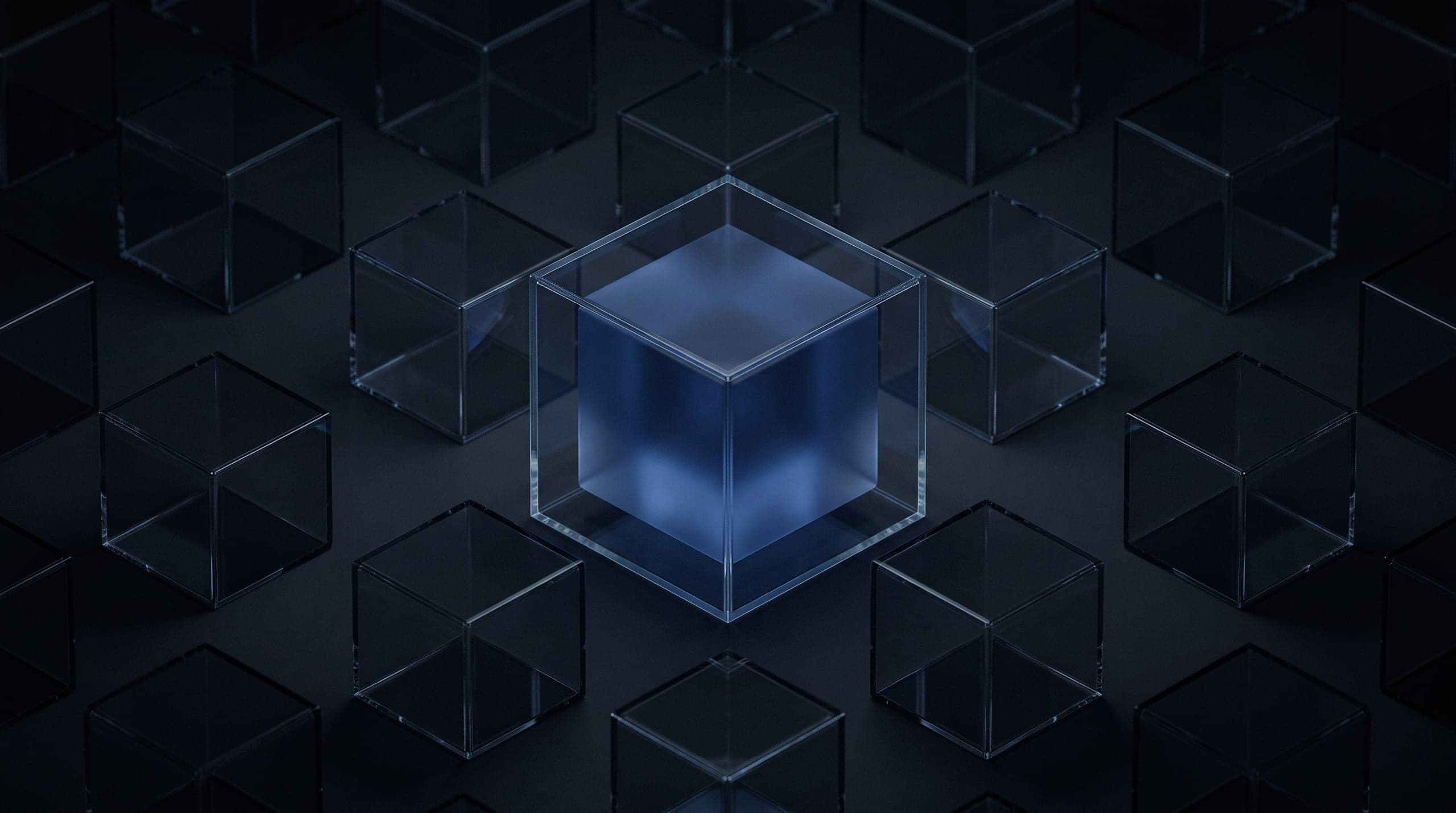 A clear glass cube holding a frosted blue core whose contents cannot be seen, among dim empty cells.