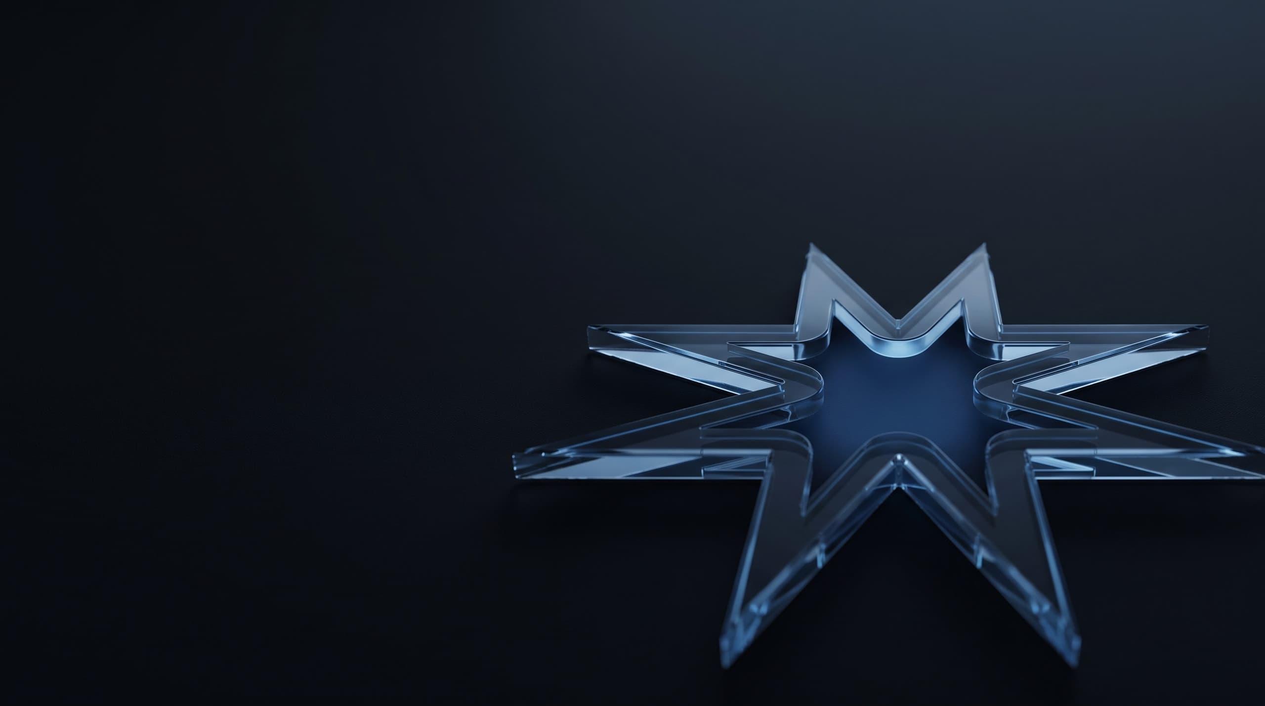 A glass Starlight star lying on its side, lit softly along its edges